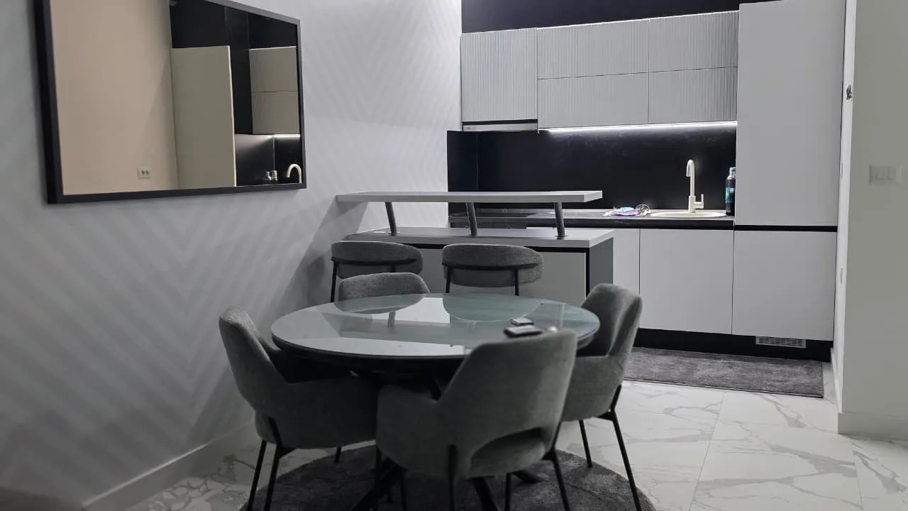 Modern kitchen with a dining table and chairs.