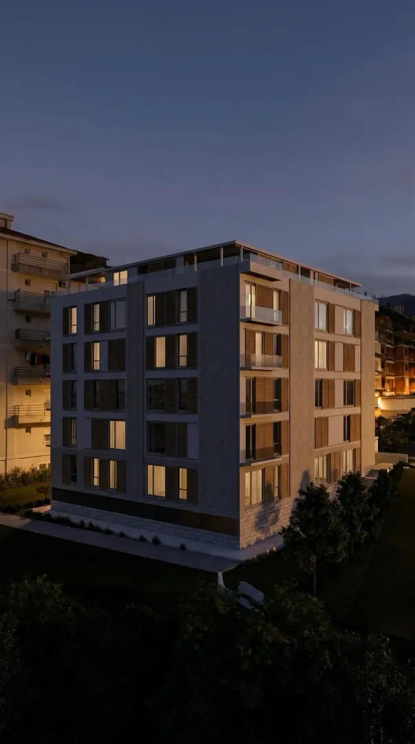 Pogled na moderno stambeno zdanje u sumrak sa osvijetljenim prozorima i terasama.