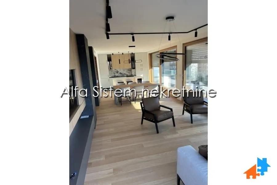 Living room connected to the dining area and kitchen in a modern apartment.