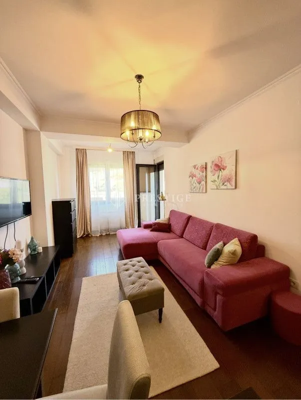 Spacious living room with a sofa set and dining table.