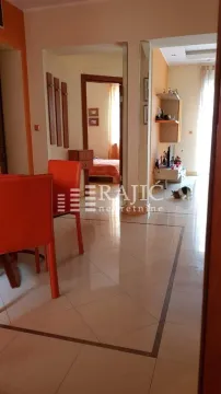 Living room with dining area and a view of the hallway. - image 6