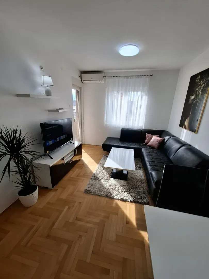 Bright living room with a black sofa.