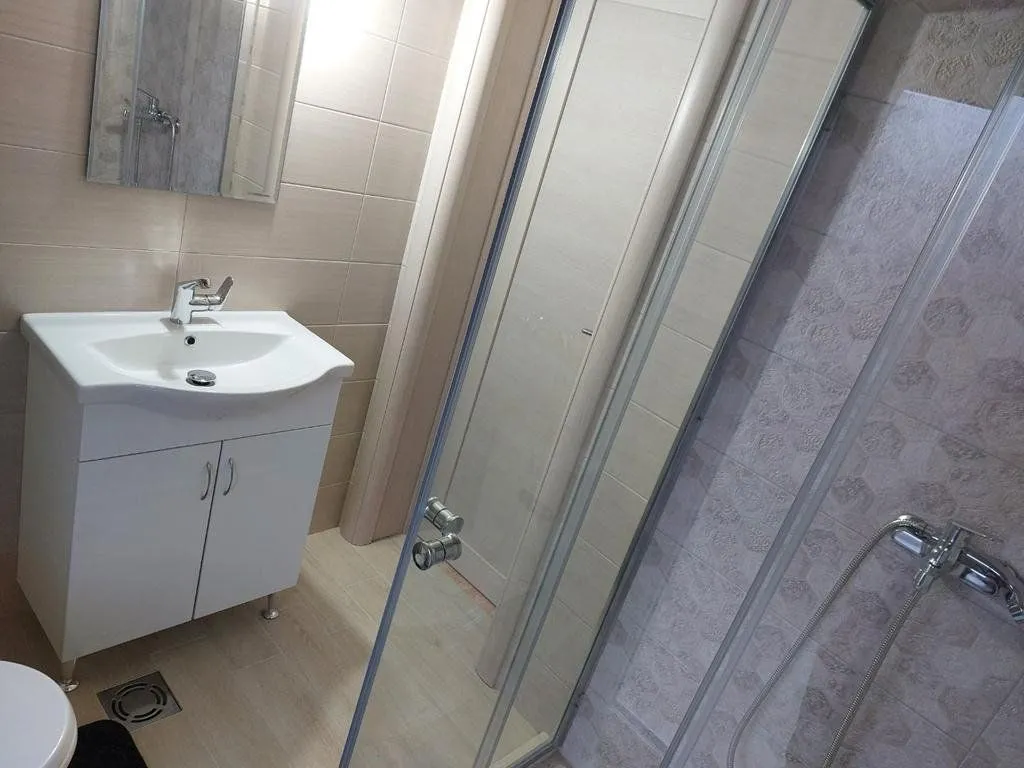 Bathroom equipped with a washbasin, mirror, and shower cabin.