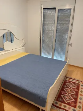 Bedroom with a double bed, mirror, and access to the terrace. - image 6