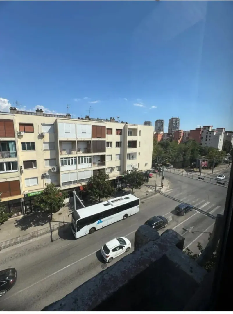 View from the window of the city street and surrounding buildings.