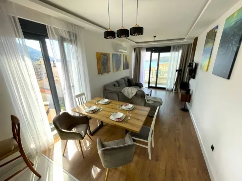 Living room with a dining area, sofa, and sea view. - image 3