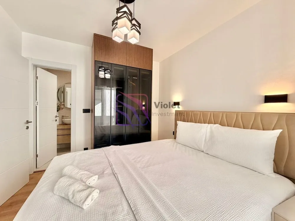 Furnished bedroom with a double bed, wardrobe, and an ensuite bathroom.