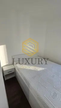 A bedroom with a double bed and a nightstand. - image 14