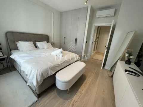 Modern bedroom with a double bed, built-in wardrobe, and wooden flooring. - image 12