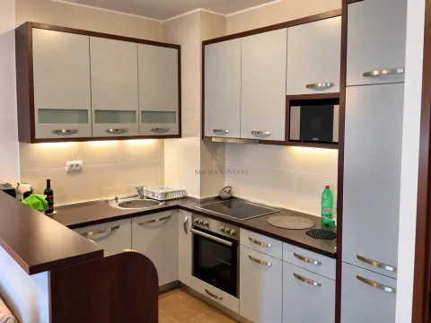 Kitchen equipped with light-toned cabinetry and built-in appliances. - image 4
