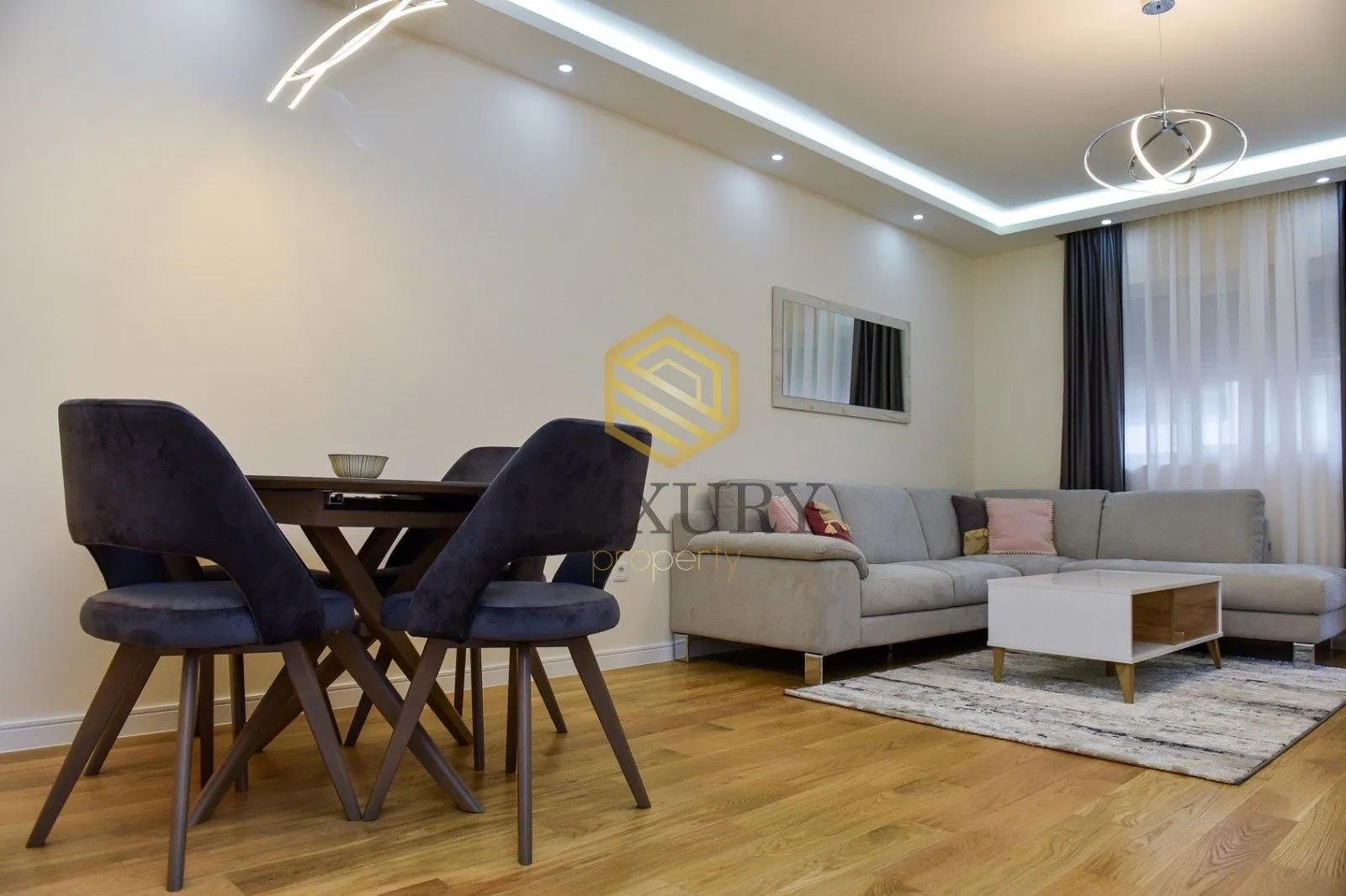 Modern living room with a sofa and a dining table.