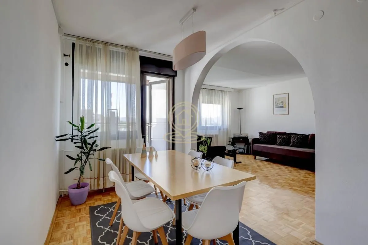 Dining area connected to the living room through an archway.