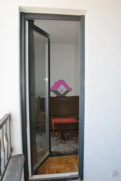 View through the open balcony door into the living room interior. - image 12
