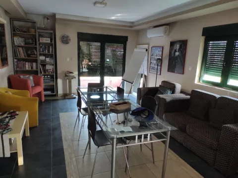 Spacious living room with a glass dining table and seating area. - image 2