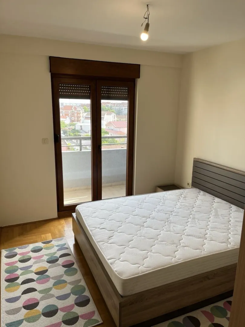 Bright bedroom with balcony access.