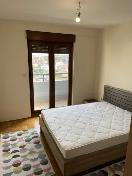 Bright bedroom with balcony access. - image 3