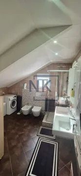 Bathroom with a shower cabin, double vanity, and washing machine in the attic. - image 10
