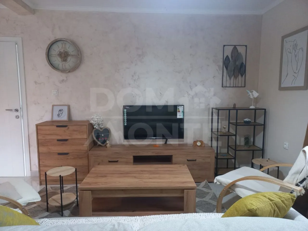 Living room furnished with furniture and a TV.