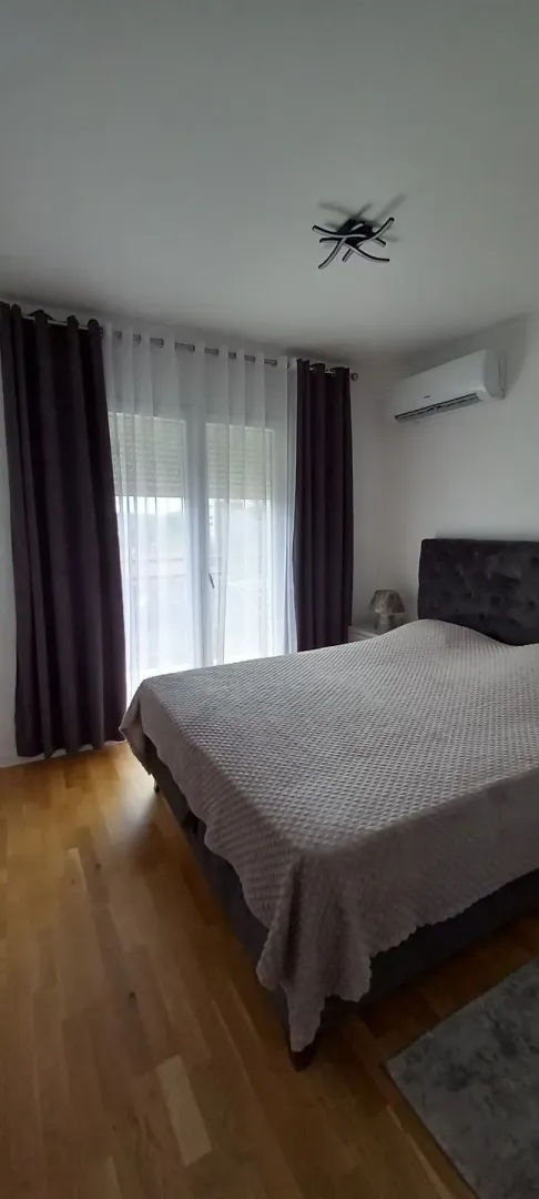 Bright bedroom with a double bed and air conditioning.