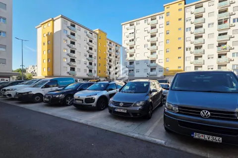 Parking area in front of residential buildings. - image 9