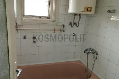 Older bathroom with a bathtub and a water heater on the wall. - image 7