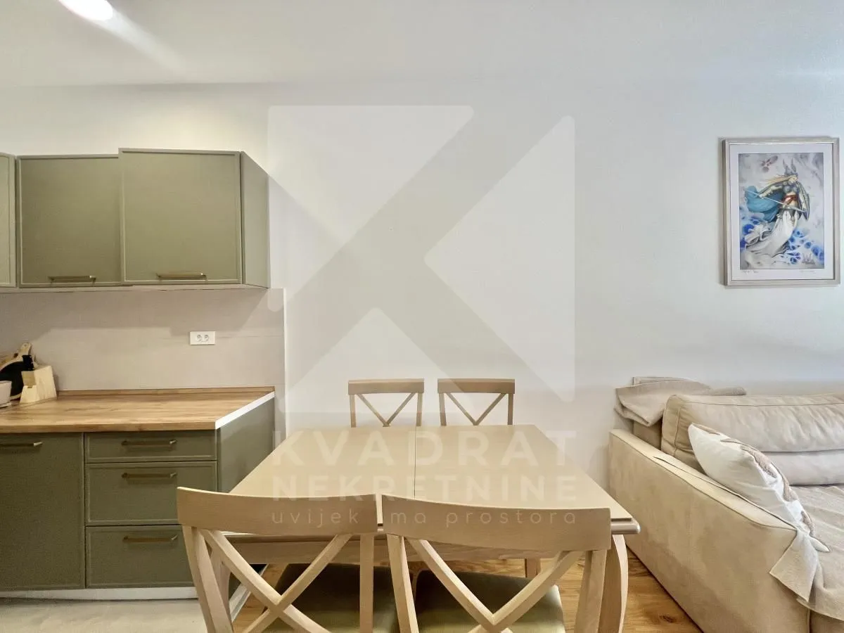 Living room with dining area and kitchen in an open-plan space.