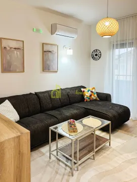 Living room with a sectional sofa, coffee table and air conditioning. - image 8