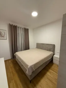 Furnished bedroom with a double bed, wardrobe, and wooden flooring. - image 6