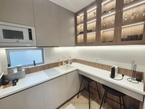 Modern kitchen with built-in cabinetry and a breakfast bar. - image 6