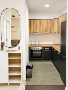 Modern kitchen with wooden elements and built-in appliances. - image 2