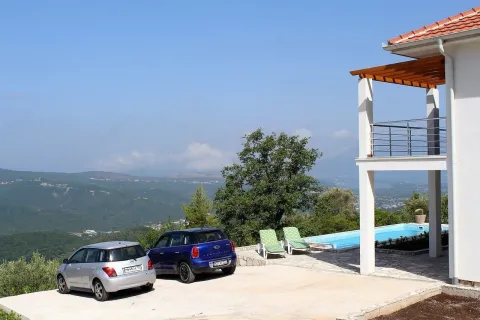 Exterior of the house with a swimming pool, parking space, and nature view. - image 16