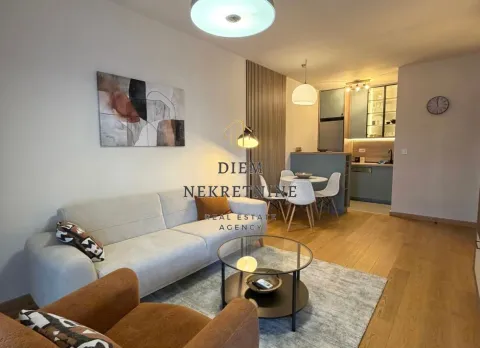 Modern living room with a sofa and dining area in an open-plan layout. - image 3