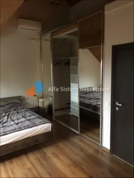 Bedroom with a double bed and a large built-in wardrobe with mirrors. - image 9