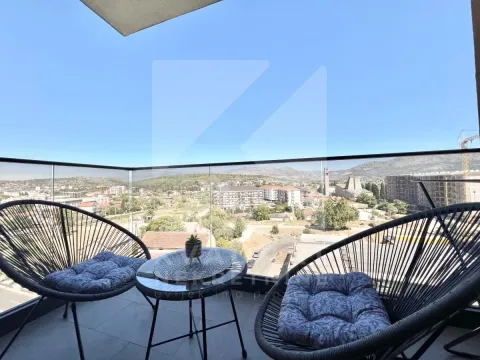 Furnished balcony with seating set and city view. - image 9