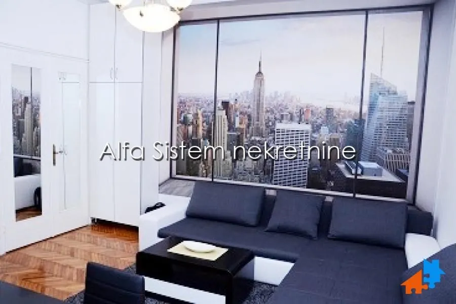 Living room with a sectional sofa and a large window with a city view.