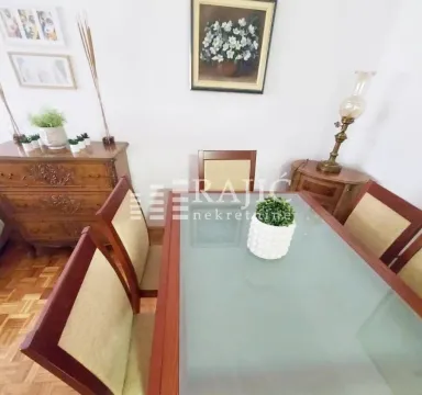 Dining room with wooden table and chairs. - image 5