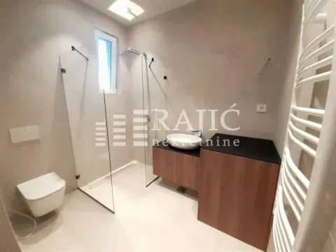 Modern bathroom with walk-in shower, vanity, and fitted sanitary ware. - image 9