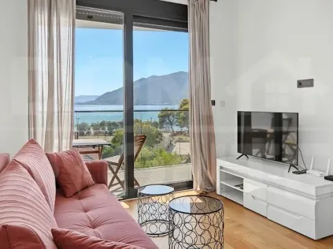 Living room with a sofa, TV, and access to a terrace with a sea view. - image 3