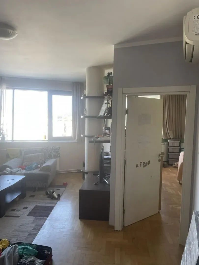 Living room with a sofa and a view towards the door leading to another room.