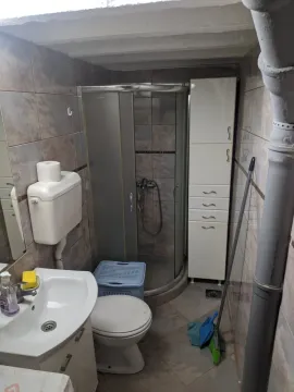 A small bathroom with a shower. - image 6