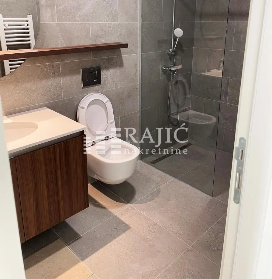 Modernly equipped bathroom with a walk-in shower.
