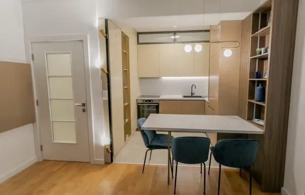 Modern kitchen with dining table and chairs.