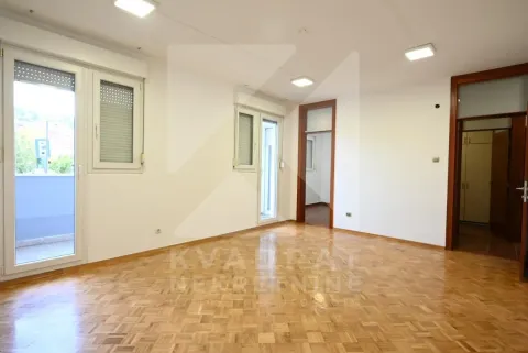 Empty living room with parquet flooring, white walls, and balcony doors. - image 8