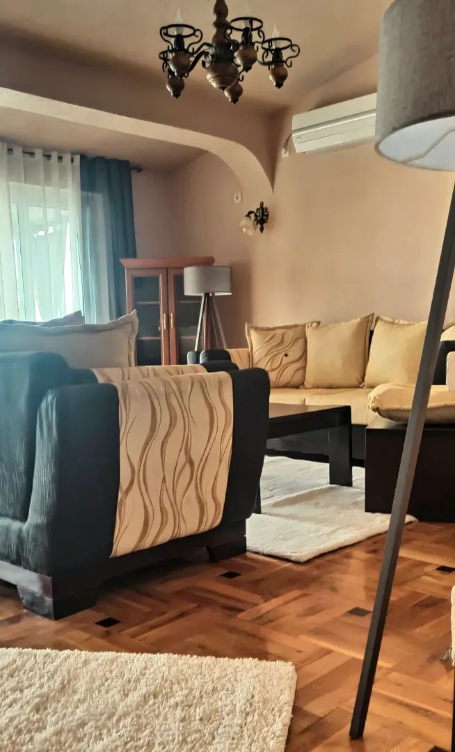 Living room with a sofa set and wooden floor.