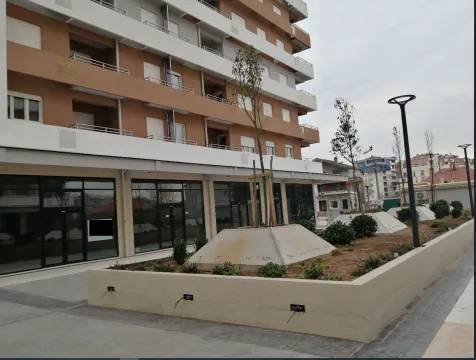 Exterior of a modern residential building with a landscaped yard in front. - image 4