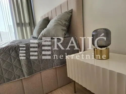 Modern bedroom with a double bed and a nightstand.