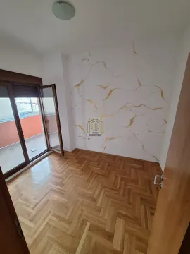 Empty room with parquet flooring and access to the terrace. - image 2