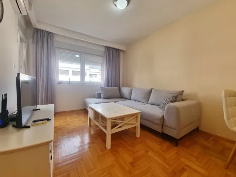Living room with a corner sofa, coffee table and TV. - image 4