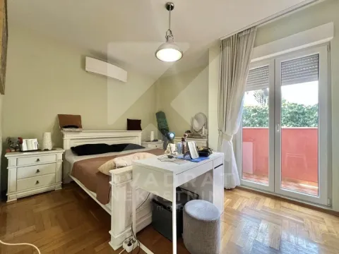 Furnished bedroom with a double bed, a desk, and access to the terrace. - image 6