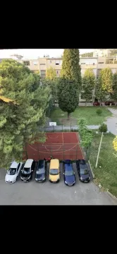 View from the window overlooking the parking lot and a basketball court. - image 5